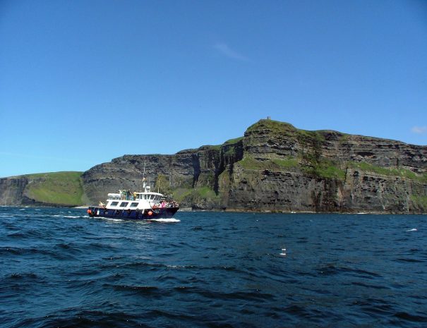 Boat tour in front of O'Brien's Tower at the Cliffs of Moher, Co. Clare